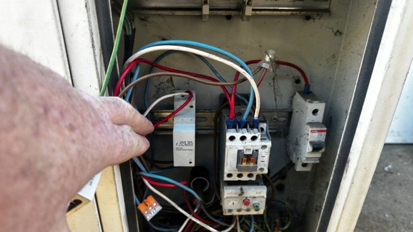 BM Refrigeration technician checking a refrigeration electrical panel