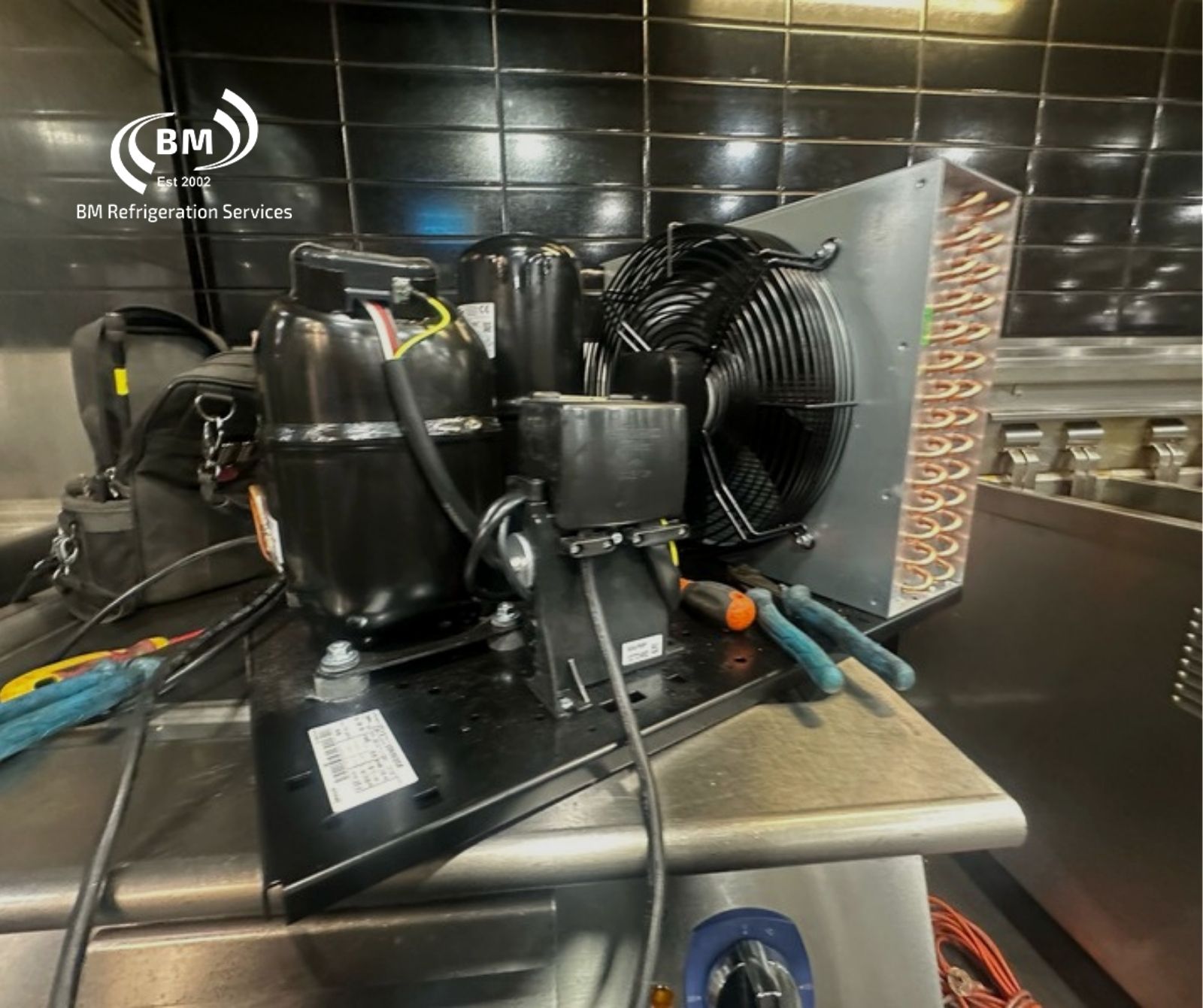 Commercial refrigeration condensing unit being serviced